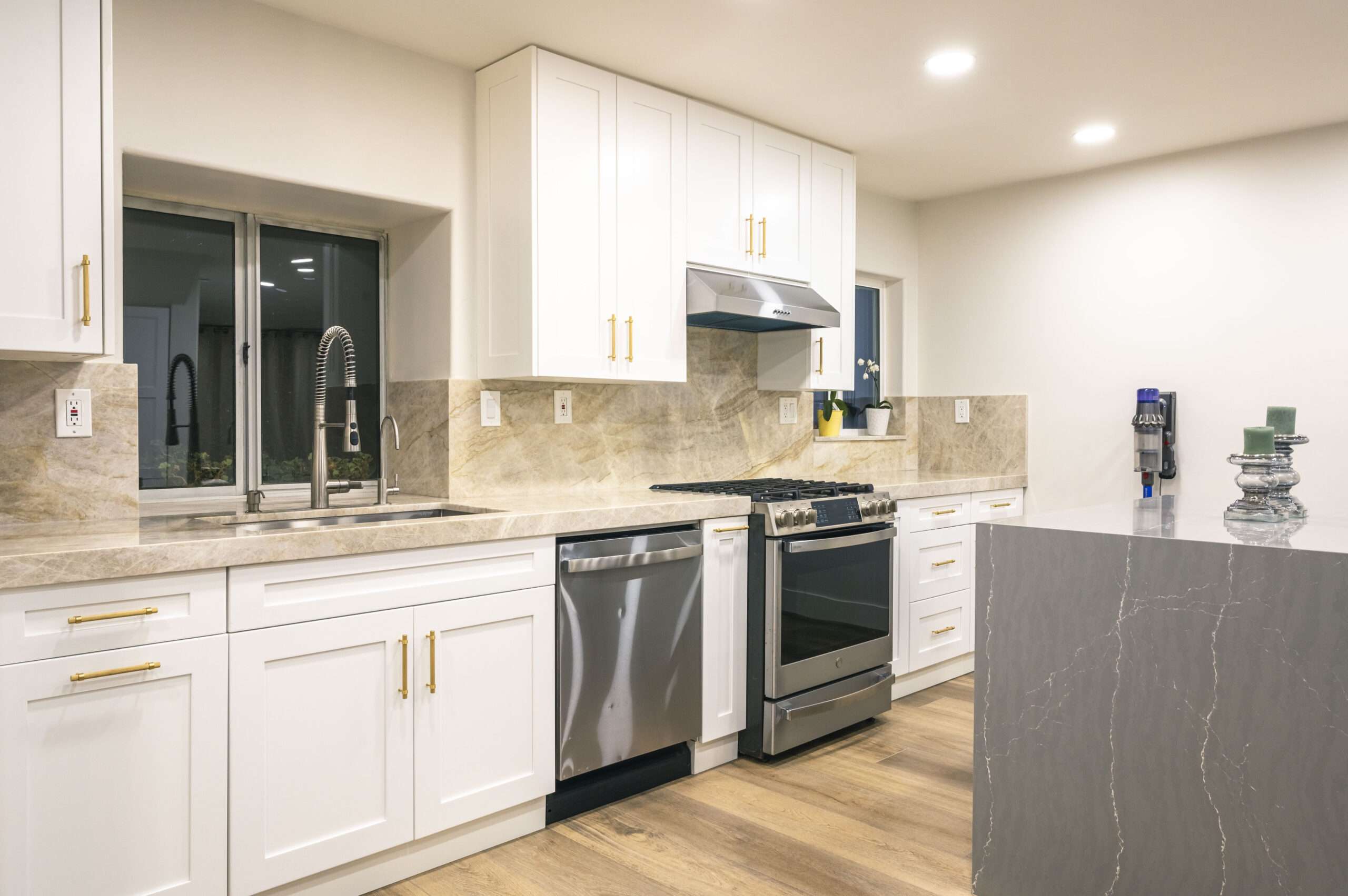 Completed sink and range wall with white shaker cabinets