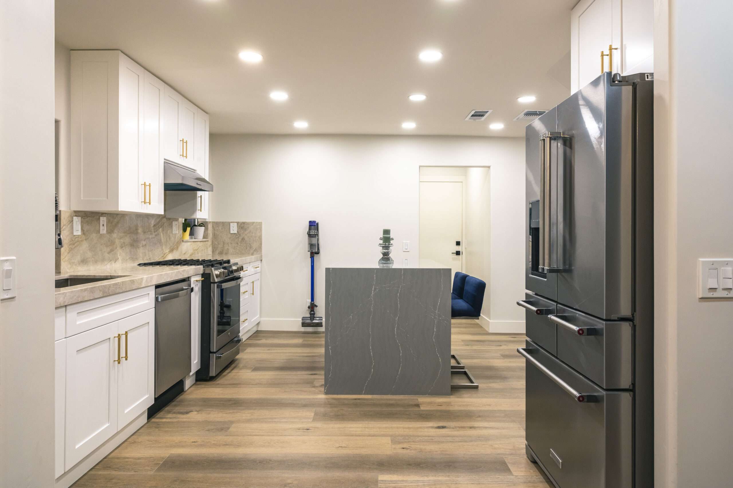 Completed kitchen viewed from the refrigerator side toward the island